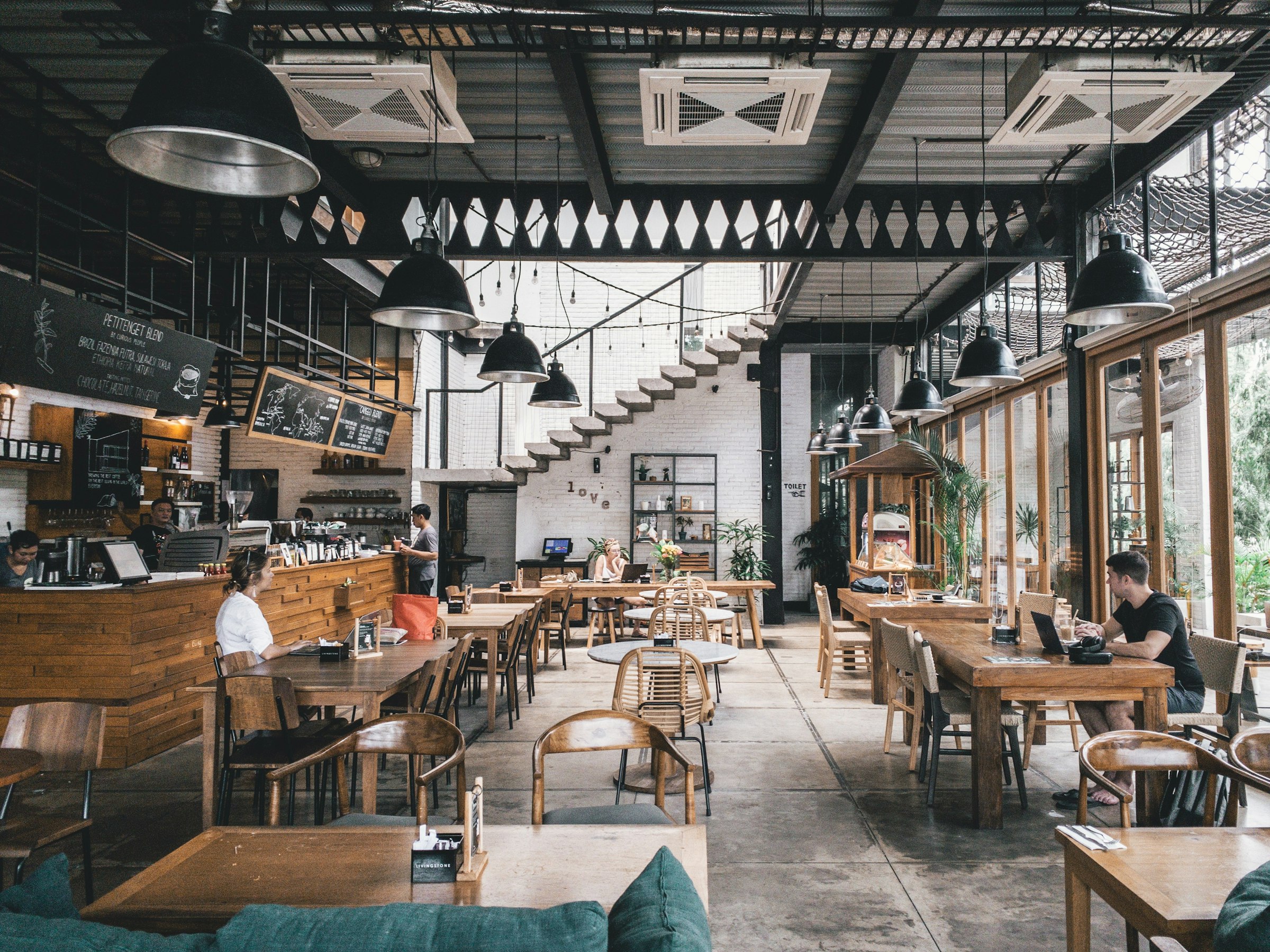 Inside Maple & Thyme: long wooden tables in warm morning light